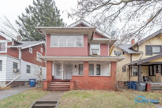 433 Islington St, Toledo, OH 43610 - view of front of home with a porch, a front lawn, and cooling unit