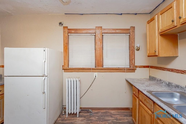 433 Islington St, Toledo, OH 43610 - kitchen with freestanding refrigerator, radiator heating unit, and dark wood-style floors