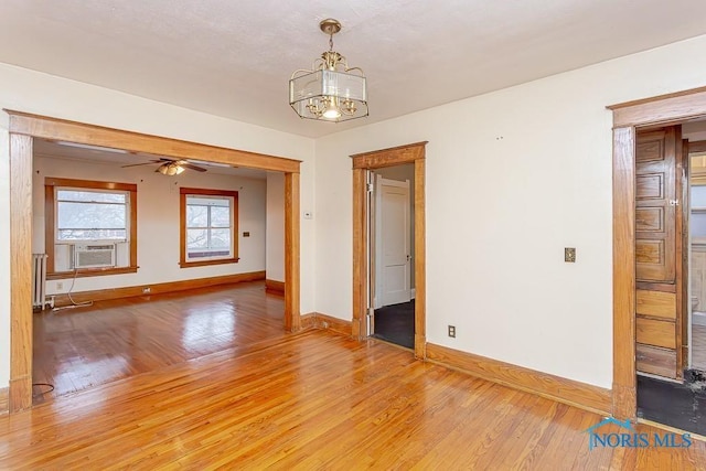 433 Islington St, Toledo, OH 43610 - spare room with light wood finished floors, a chandelier, radiator, and cooling unit