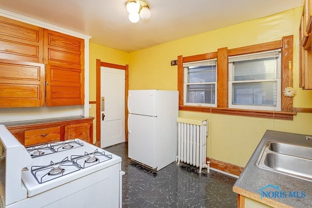 433 Islington St, Toledo, OH 43610 - kitchen with white appliances, radiator, and brown cabinetry
