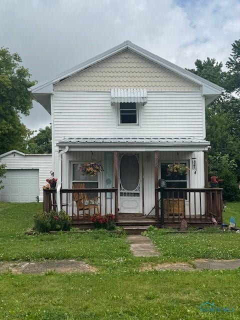 422 Eben Ave, Findlay, OH 45840 - view of front facade with covered porch, a garage, and a front yard