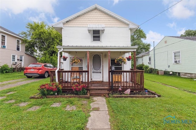422 Eben Ave, Findlay, OH 45840 - view of front of home featuring covered porch, a front yard, and cooling unit