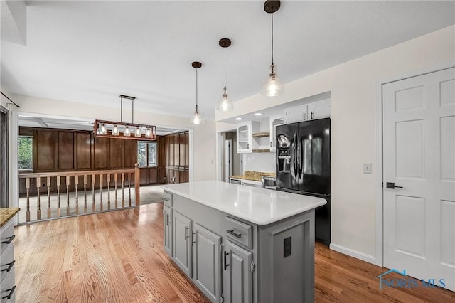 1626 Woodstream Rd, Perrysburg, OH 43551 - kitchen featuring black refrigerator with ice dispenser, gray cabinetry, light wood-style floors, and light countertops