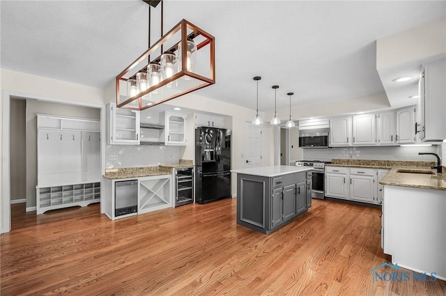 1626 Woodstream Rd, Perrysburg, OH 43551 - kitchen featuring stainless steel appliances, beverage cooler, gray cabinets, decorative backsplash, and a kitchen island