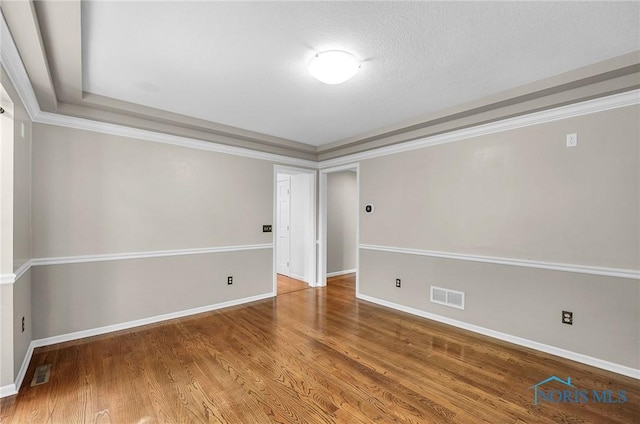 1626 Woodstream Rd, Perrysburg, OH 43551 - empty room with wood finished floors, a tray ceiling, and ornamental molding