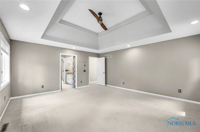 1626 Woodstream Rd, Perrysburg, OH 43551 - unfurnished bedroom with a tray ceiling, light colored carpet, recessed lighting, ensuite bath, and ceiling fan