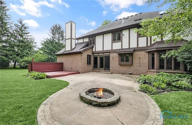 1626 Woodstream Rd, Perrysburg, OH 43551 - rear view of house featuring a patio, brick siding, a lawn, stucco siding, and a fire pit