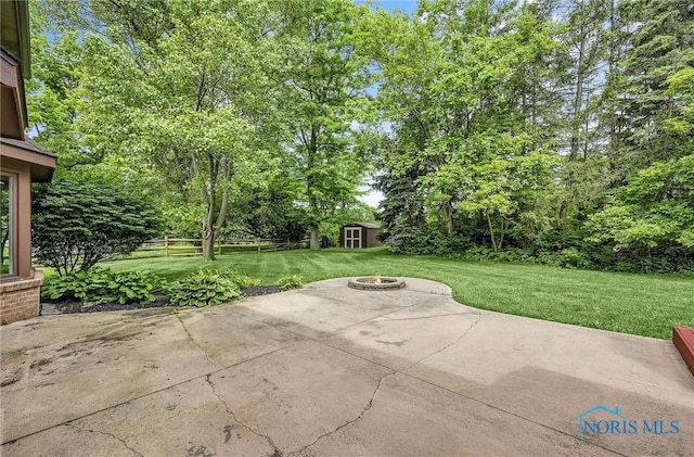 1626 Woodstream Rd, Perrysburg, OH 43551 - view of patio / terrace with a fire pit, an outdoor structure, and view of scattered trees