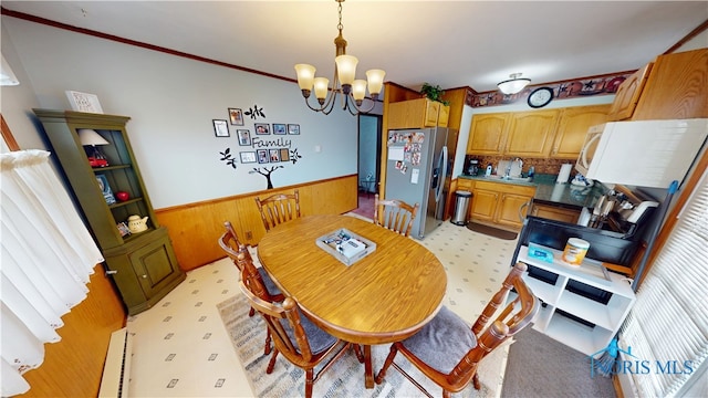 43 Longfellow Dr, Tiffin, OH 44883 - dining room featuring a wainscoted wall, a chandelier, wood walls, and ornamental molding