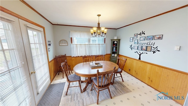 43 Longfellow Dr, Tiffin, OH 44883 - dining room featuring a wainscoted wall, a chandelier, wood walls, and ornamental molding