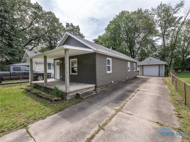 5161 Langham Dr, Sylvania, OH 43560 - view of front of home with a porch, a garage, driveway, and an outbuilding
