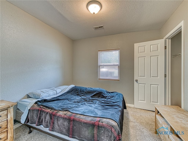 5161 Langham Dr, Sylvania, OH 43560 - bedroom with a textured ceiling, light carpet, and a textured wall