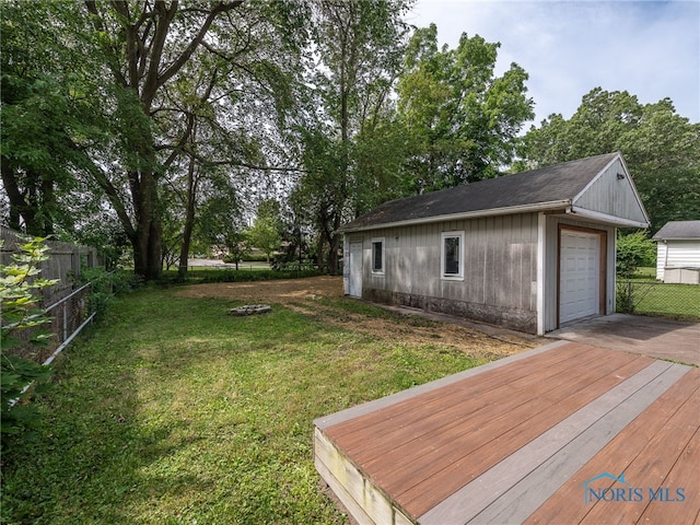 5161 Langham Dr, Sylvania, OH 43560 - view of yard featuring concrete driveway, an outbuilding, a garage, and a deck