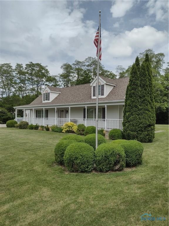 11550 County Road 26th 1, Fayette, OH 43521 - view of front of home featuring a porch, a shingled roof, and a front lawn