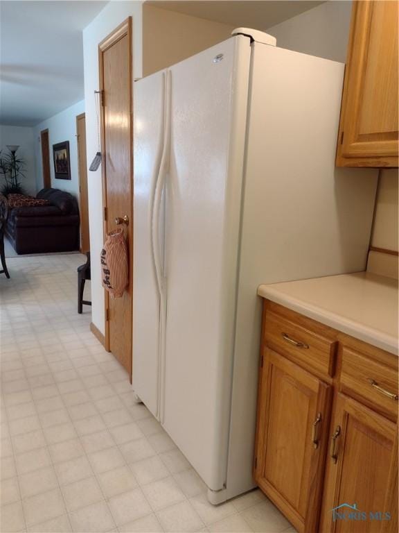 11550 County Road 26th 1, Fayette, OH 43521 - kitchen with freestanding refrigerator, light countertops, open floor plan, light flooring, and brown cabinets