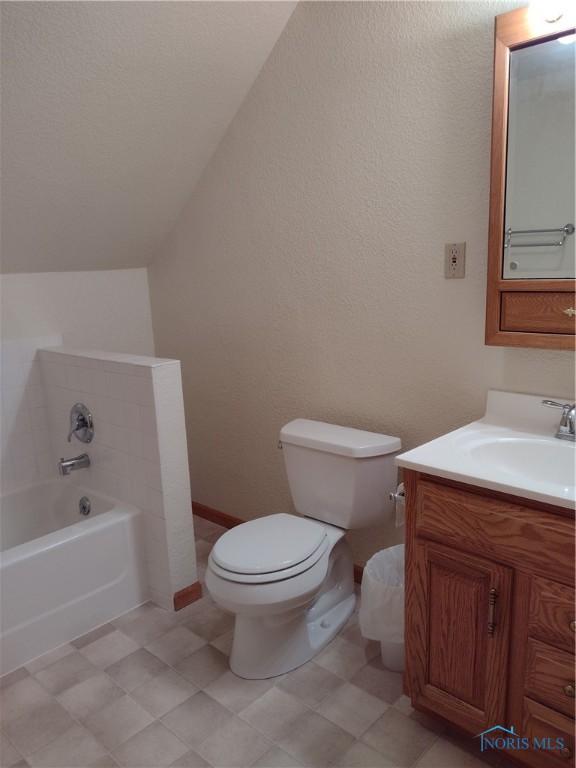 11550 County Road 26th 1, Fayette, OH 43521 - bathroom with a bath, vanity, and lofted ceiling