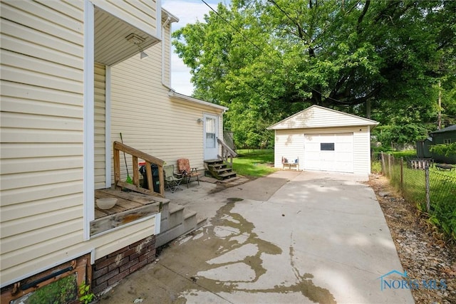 4128 Douglas Rd, Toledo, OH 43613 - view of patio / terrace featuring entry steps, concrete driveway, an outbuilding, and a detached garage