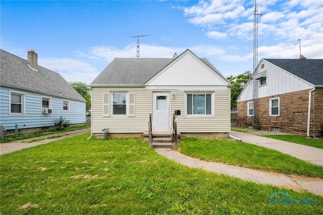 42 California Blvd, Toledo, OH 43612 - bungalow-style house with a front yard, cooling unit, entry steps, and board and batten siding