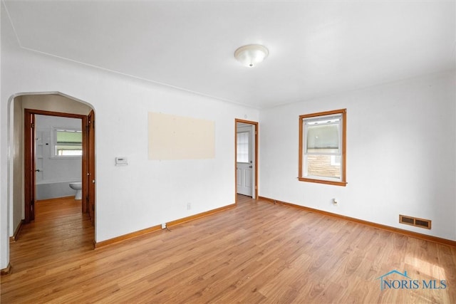 42 California Blvd, Toledo, OH 43612 - empty room with arched walkways and light wood-type flooring