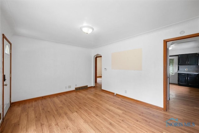 42 California Blvd, Toledo, OH 43612 - spare room featuring arched walkways and light wood-style flooring