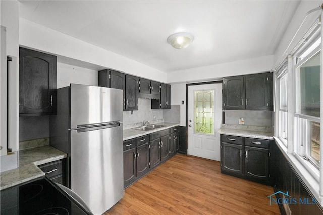 42 California Blvd, Toledo, OH 43612 - kitchen with freestanding refrigerator, light countertops, light wood-style floors, and healthy amount of natural light