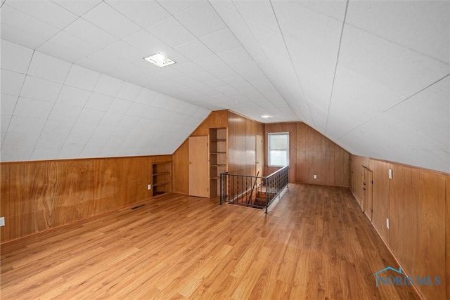 42 California Blvd, Toledo, OH 43612 - additional living space with wood walls, light wood-style flooring, and vaulted ceiling
