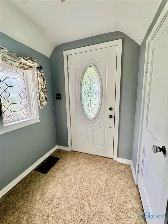 908 E High St, Hicksville, OH 43526 - foyer entrance featuring lofted ceiling, carpet flooring, and plenty of natural light