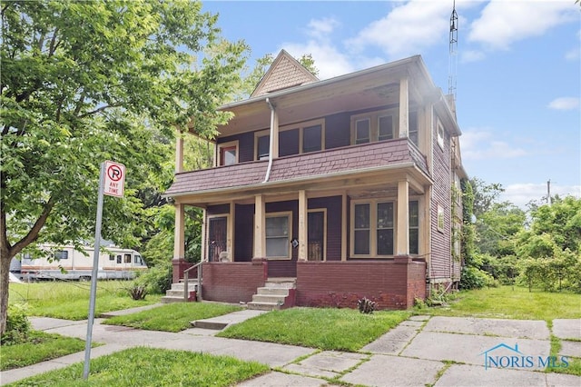 2360 Maplewood Ave, Toledo, OH 43620 - view of front of property featuring a balcony, a porch, and a front yard