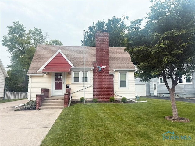 1007 Leonard Ct, Fostoria, OH 44830 - view of front of home featuring a front lawn, entry steps, a chimney, and roof with shingles