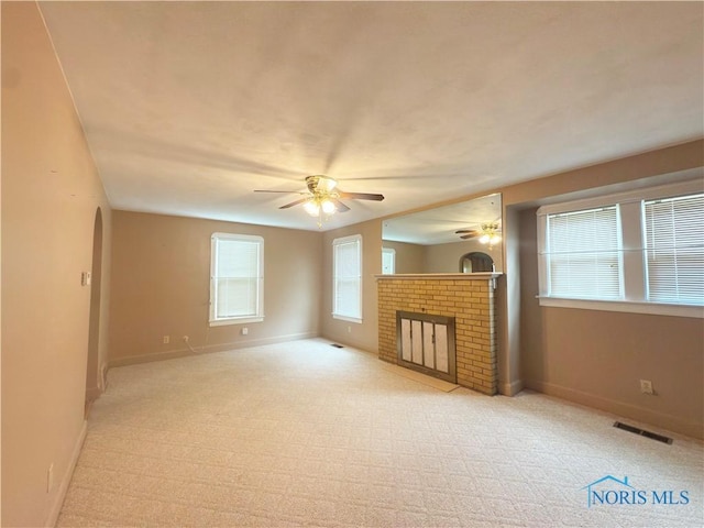 1007 Leonard Ct, Fostoria, OH 44830 - unfurnished living room featuring a ceiling fan, carpet, and a fireplace