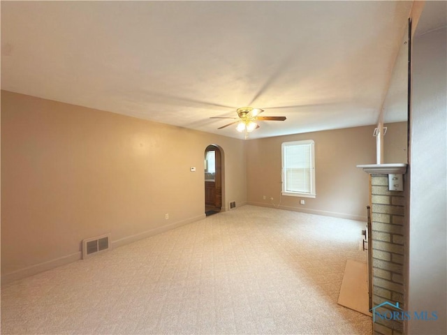 1007 Leonard Ct, Fostoria, OH 44830 - empty room featuring arched walkways, a ceiling fan, and carpet flooring