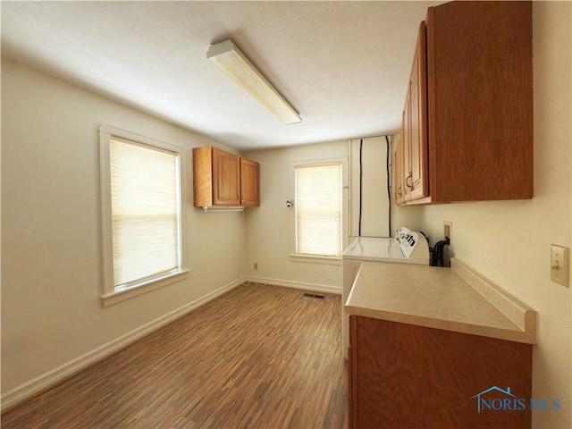 1007 Leonard Ct, Fostoria, OH 44830 - kitchen with brown cabinetry, wood finished floors, and light countertops