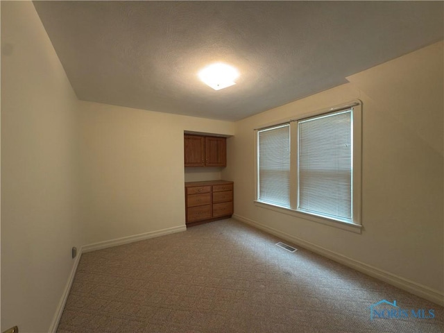 1007 Leonard Ct, Fostoria, OH 44830 - empty room featuring baseboards and light carpet