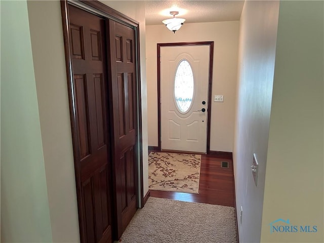 2440 Bluestone Dr, Findlay, OH 45840 - foyer featuring a textured ceiling and wood finished floors