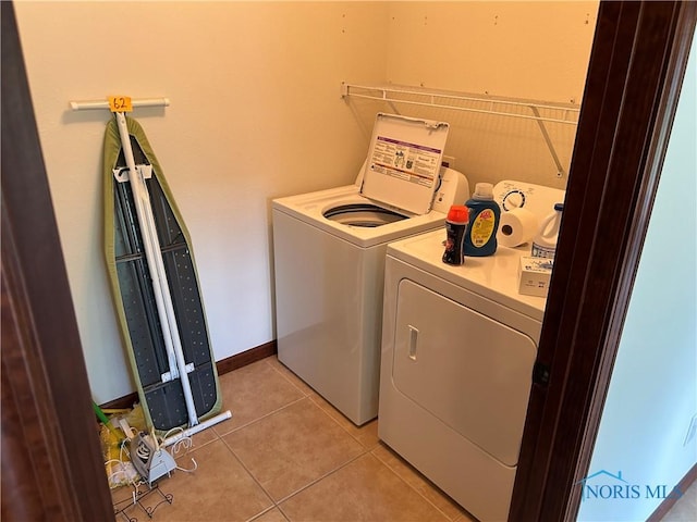 2440 Bluestone Dr, Findlay, OH 45840 - laundry area with washing machine and dryer and light tile patterned flooring