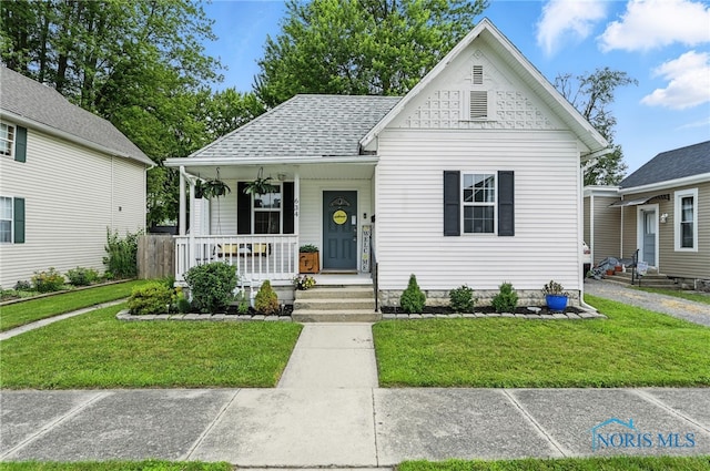 634 Cherry St, Findlay, OH 45840 - view of front of property with a porch, a front lawn, and roof with shingles