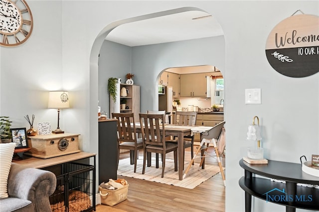 634 Cherry St, Findlay, OH 45840 - dining area with arched walkways and light wood-type flooring
