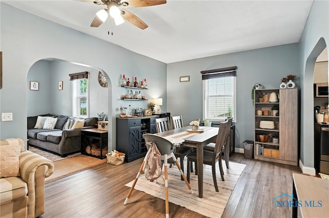 634 Cherry St, Findlay, OH 45840 - dining area featuring arched walkways, plenty of natural light, ceiling fan, and light wood finished floors