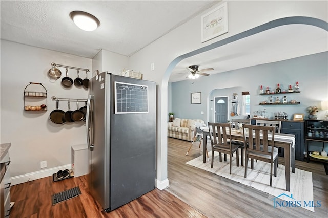 634 Cherry St, Findlay, OH 45840 - kitchen with arched walkways, freestanding refrigerator, wood finished floors, and a ceiling fan