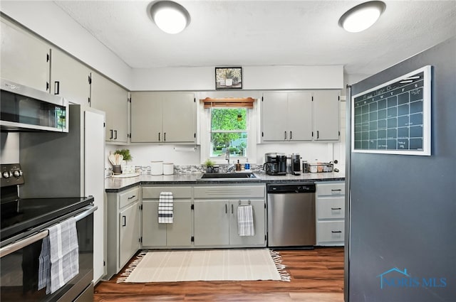 634 Cherry St, Findlay, OH 45840 - kitchen with appliances with stainless steel finishes, dark wood-style floors, and dark countertops