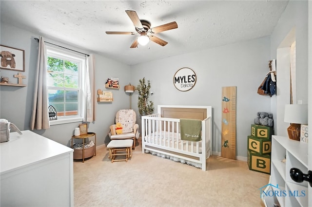 634 Cherry St, Findlay, OH 45840 - bedroom with a crib, light colored carpet, and a ceiling fan