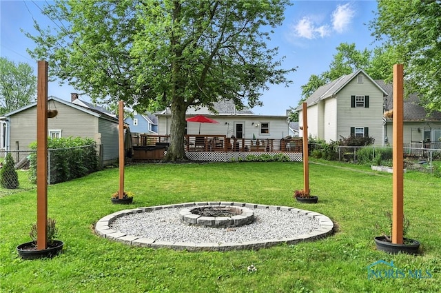 634 Cherry St, Findlay, OH 45840 - fenced backyard featuring an outdoor fire pit and a wooden deck