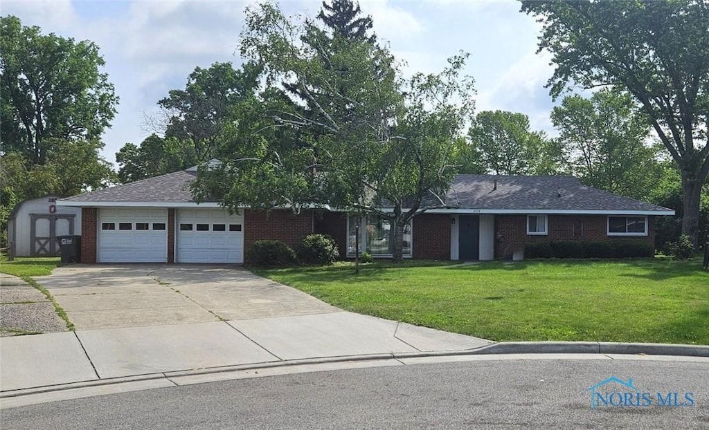 4010 Wreford Ct, Toledo, OH 43614 - single story home featuring a front yard, driveway, a garage, a shed, and brick siding