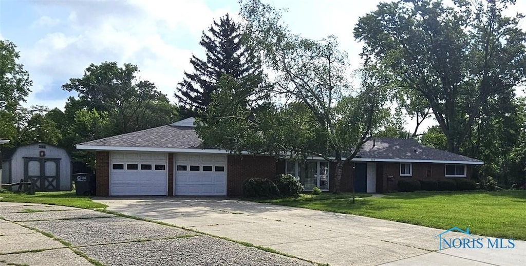 4010 Wreford Ct, Toledo, OH 43614 - single story home featuring concrete driveway, a front yard, an attached garage, a storage unit, and brick siding
