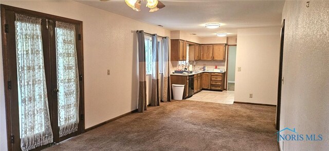 4010 Wreford Ct, Toledo, OH 43614 - kitchen featuring light carpet, light countertops, brown cabinets, and dishwashing machine