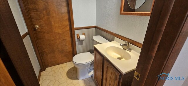 4010 Wreford Ct, Toledo, OH 43614 - bathroom featuring vanity, a textured wall, and wainscoting