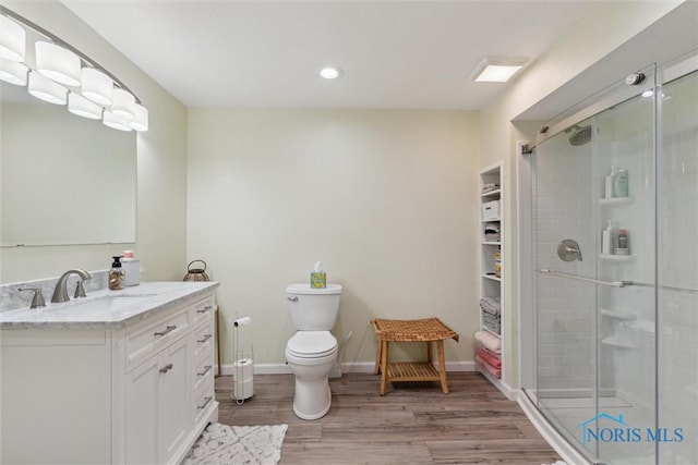 2393 Woods Edge Rd, Perrysburg, OH 43551 - full bathroom featuring wood finished floors, vanity, a stall shower, and recessed lighting