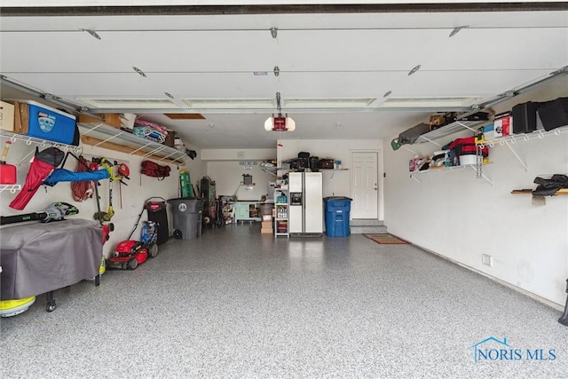 2393 Woods Edge Rd, Perrysburg, OH 43551 - garage with a garage door opener and white refrigerator with ice dispenser