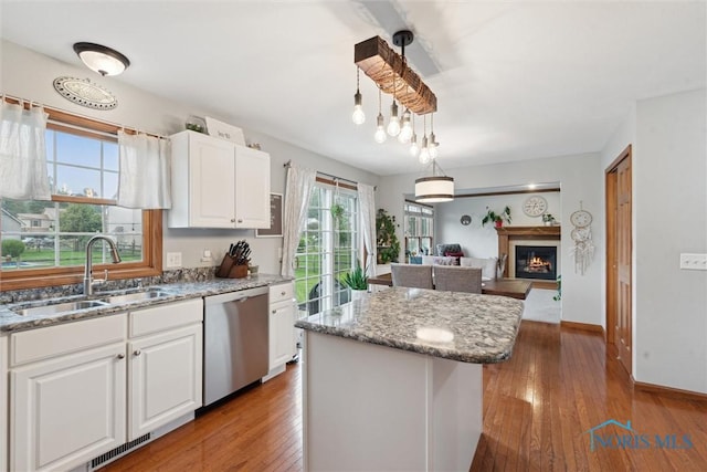 2393 Woods Edge Rd, Perrysburg, OH 43551 - kitchen featuring dishwasher, wood-type flooring, white cabinets, a center island, and light stone countertops