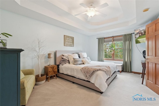 2393 Woods Edge Rd, Perrysburg, OH 43551 - bedroom featuring light carpet, a tray ceiling, and ceiling fan